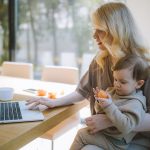 Woman Carrying her Baby and Working on a Laptop - work from home outfits