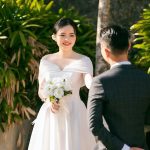 Photo of a Bride with a Bridal Bouquet Looking at a Groom - spring wedding themes for 2023