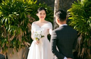 Photo of a Bride with a Bridal Bouquet Looking at a Groom - spring wedding themes for 2023