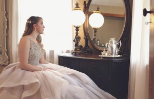 Woman Wearing Gown Looking at Mirror - spring formal dresses