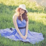 Portrait of a Smiling Young Woman in Grass - cute spring midi dresses