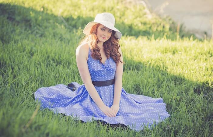 Portrait of a Smiling Young Woman in Grass - cute spring midi dresses
