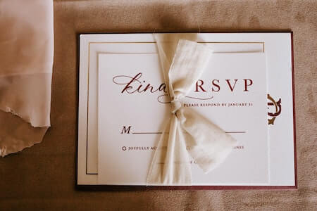 Invitation card with the inscription tied with ribbon - inviting coworkers to wedding