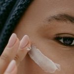 Woman applying Facial Cream on Face - best drugstore eye cream