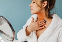 Photo of a Woman Applying Brown Cream to Her Neck - best neck firming cream