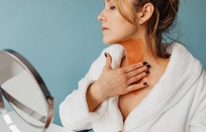Photo of a Woman Applying Brown Cream to Her Neck - best neck firming cream