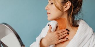 Photo of a Woman Applying Brown Cream to Her Neck - best neck firming cream