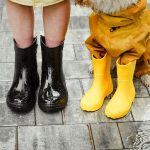 Person in Black Rain Boots Beside a Dog Wearing Yellow Rain Boots - waterproof walking shoes for women