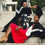 Women posing in graduation gowns - graduation picture ideas