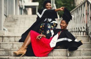 Women posing in graduation gowns - graduation picture ideas