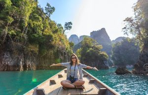 Photo of Woman Sitting on Boat Spreading Her Arms - summer vacation packages