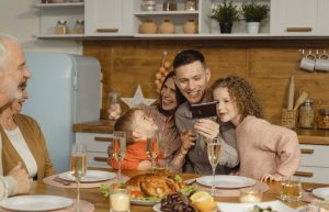 A Happy Family Bonding Time Sitting on a Dining Table - fathers day dinner ideas