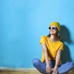 Woman in Yellow Shirt Sitting on Brown Wooden Floor - cute summer tops for women