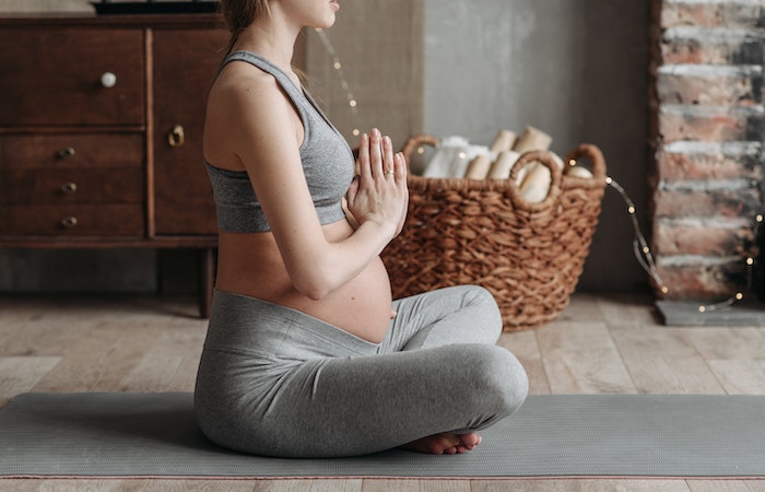 A Pregnant Woman Wearing Gray Tank Top Meditating - maternity sweatpants