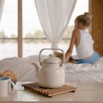 Young Girl Sitting on Bed with Breakfast on Table - birth control near me