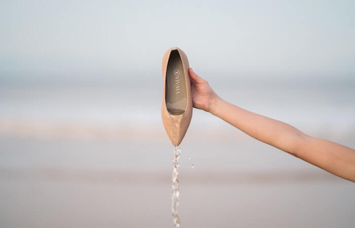 Person Holding a Wet Brown Flat Shoe - nude flat shoes for all occasions