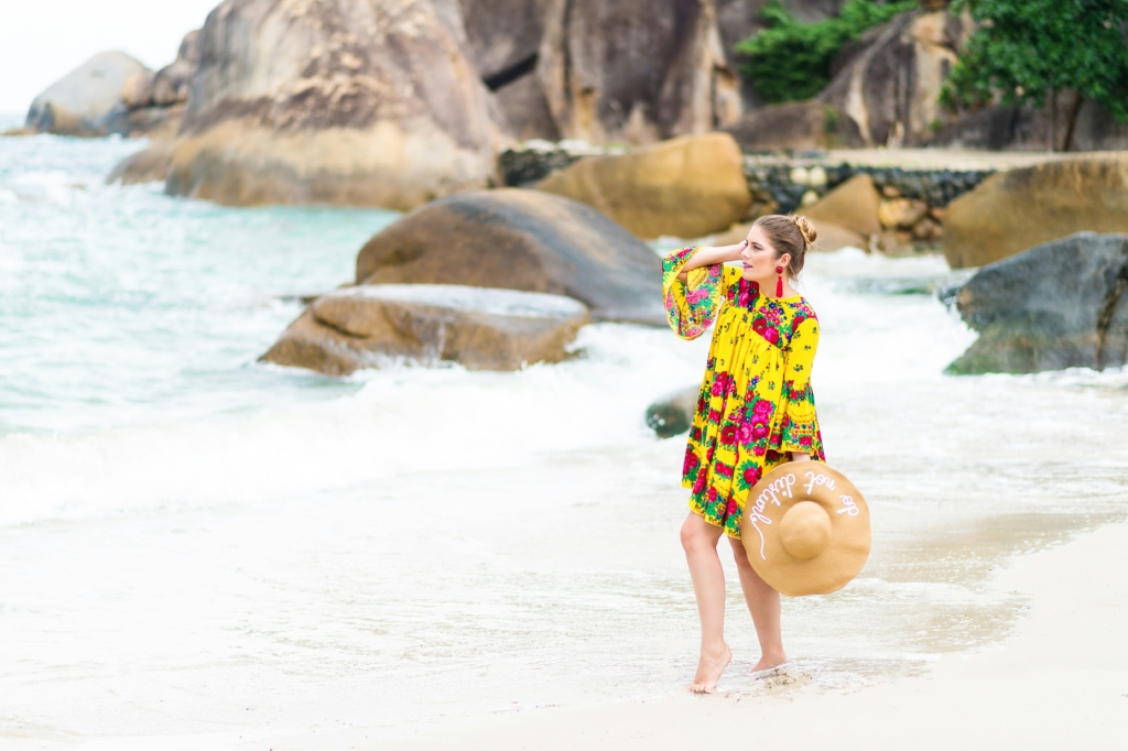 woman walking on the beach beach hairstyles that last easy beach hairstyles