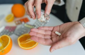 person holding vitamin pills - magnesium breakthrough