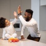 father giving daughter high-five