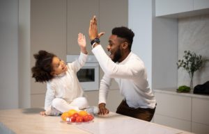 father giving daughter high-five