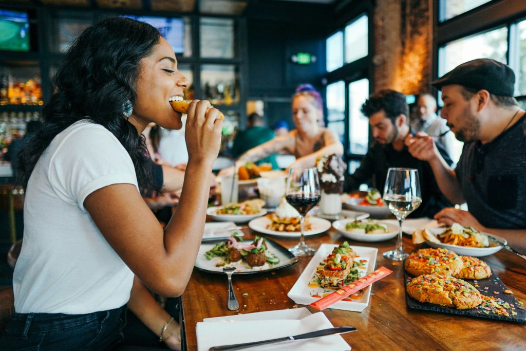 gastronomic getaways - woman eating at restaurant