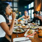 gastronomic getaways - woman eating at restaurant