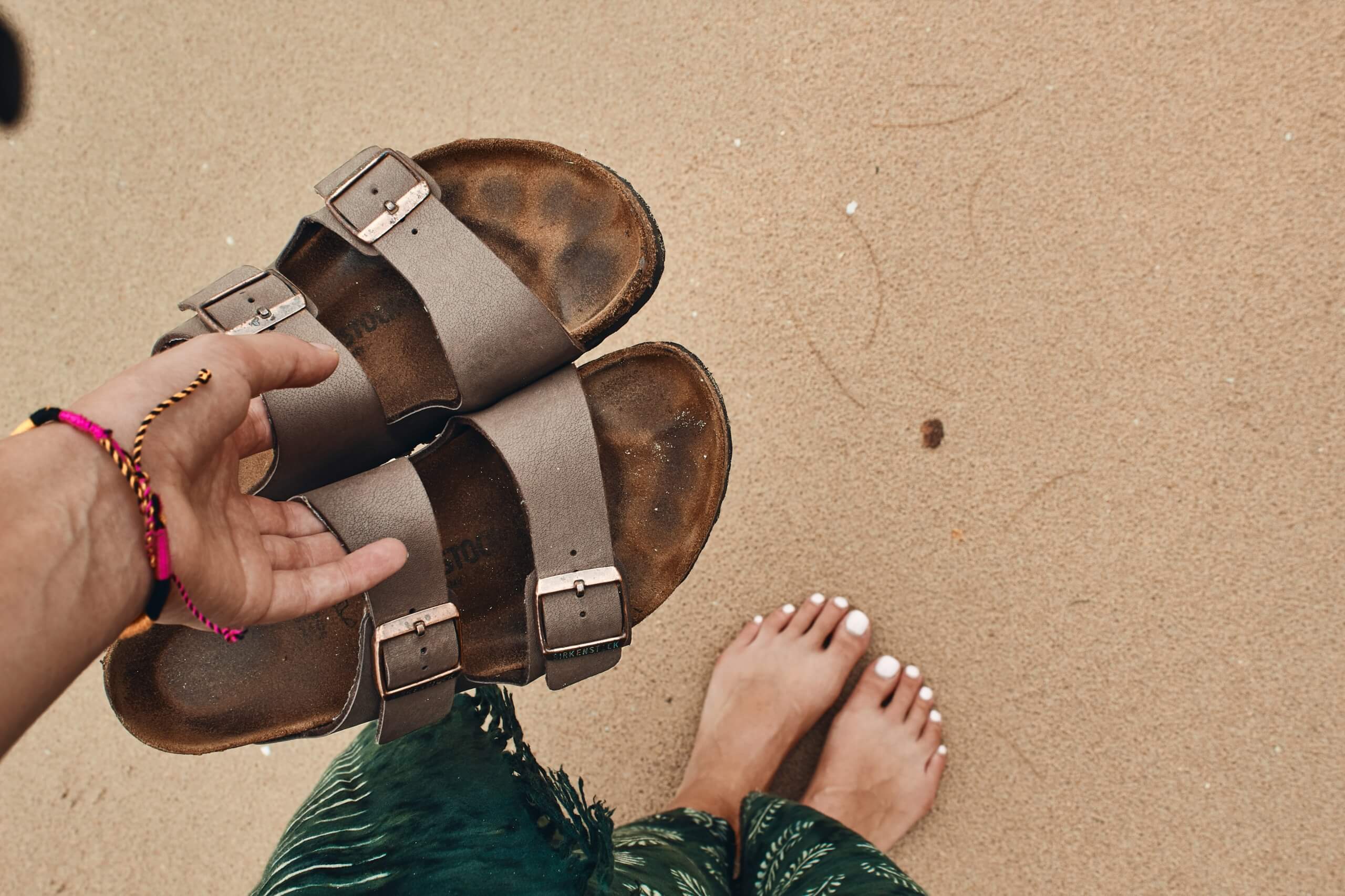 woman holding shoes - what to pack for a cruise