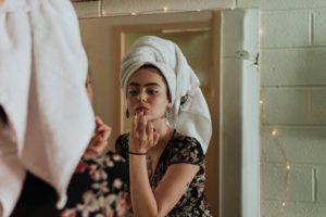 Nighttime skincare benefits - woman doing her makeup