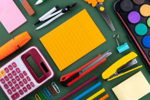 Classroom Supplies for Staff - school supplies on green background