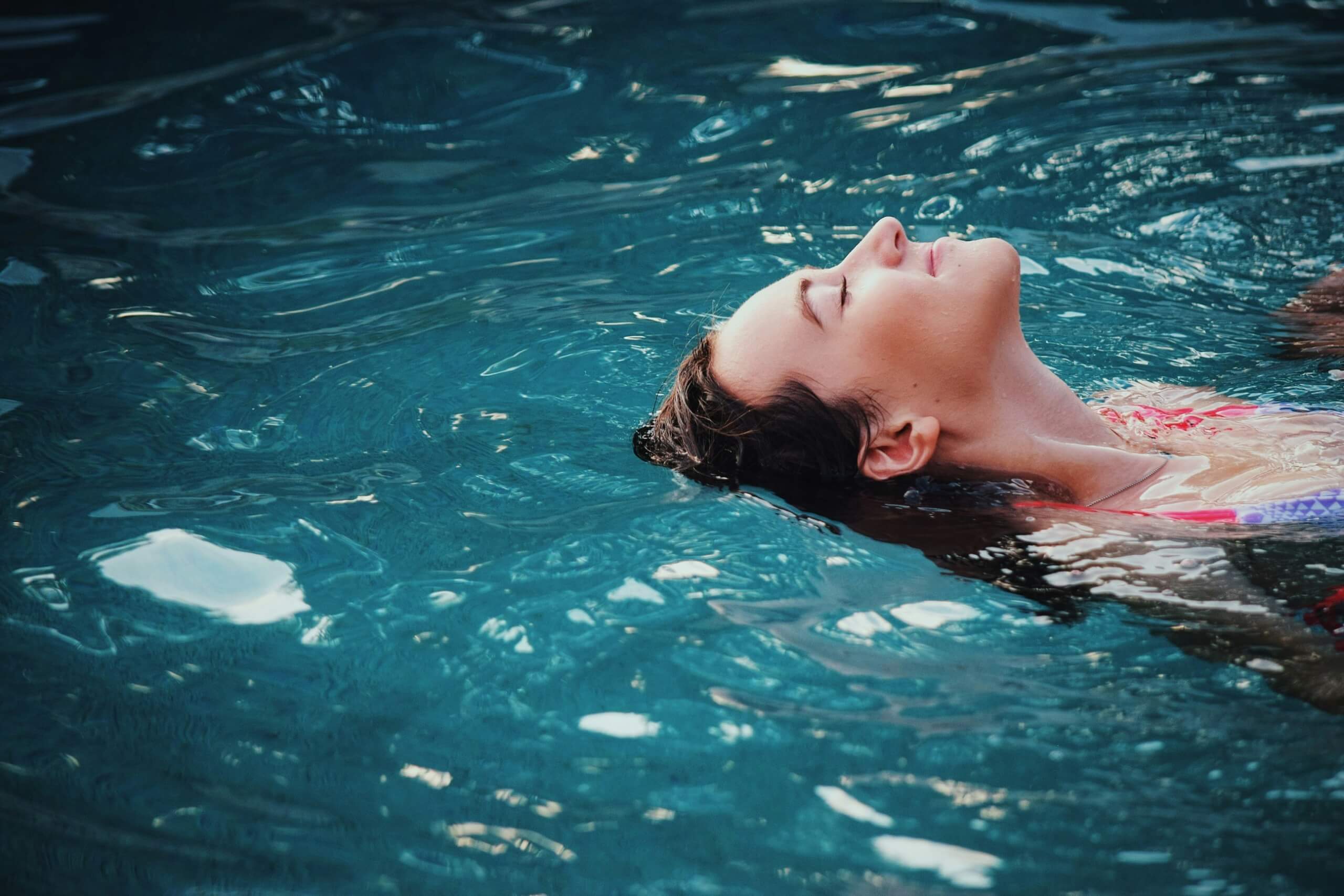 wellness and self-care escapes - lady relaxing in pool