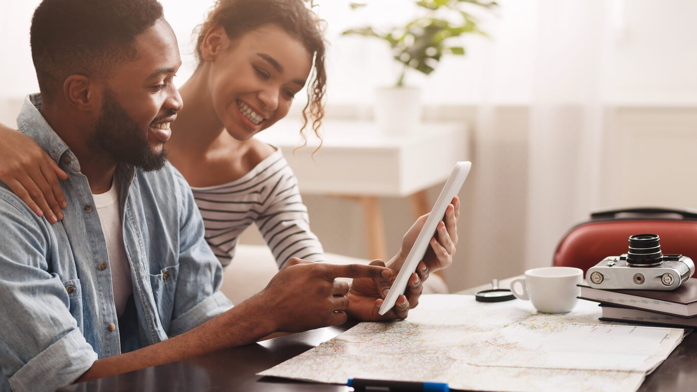 Planning vacation. Couple using tablet, searching places to visit - weekend getaways