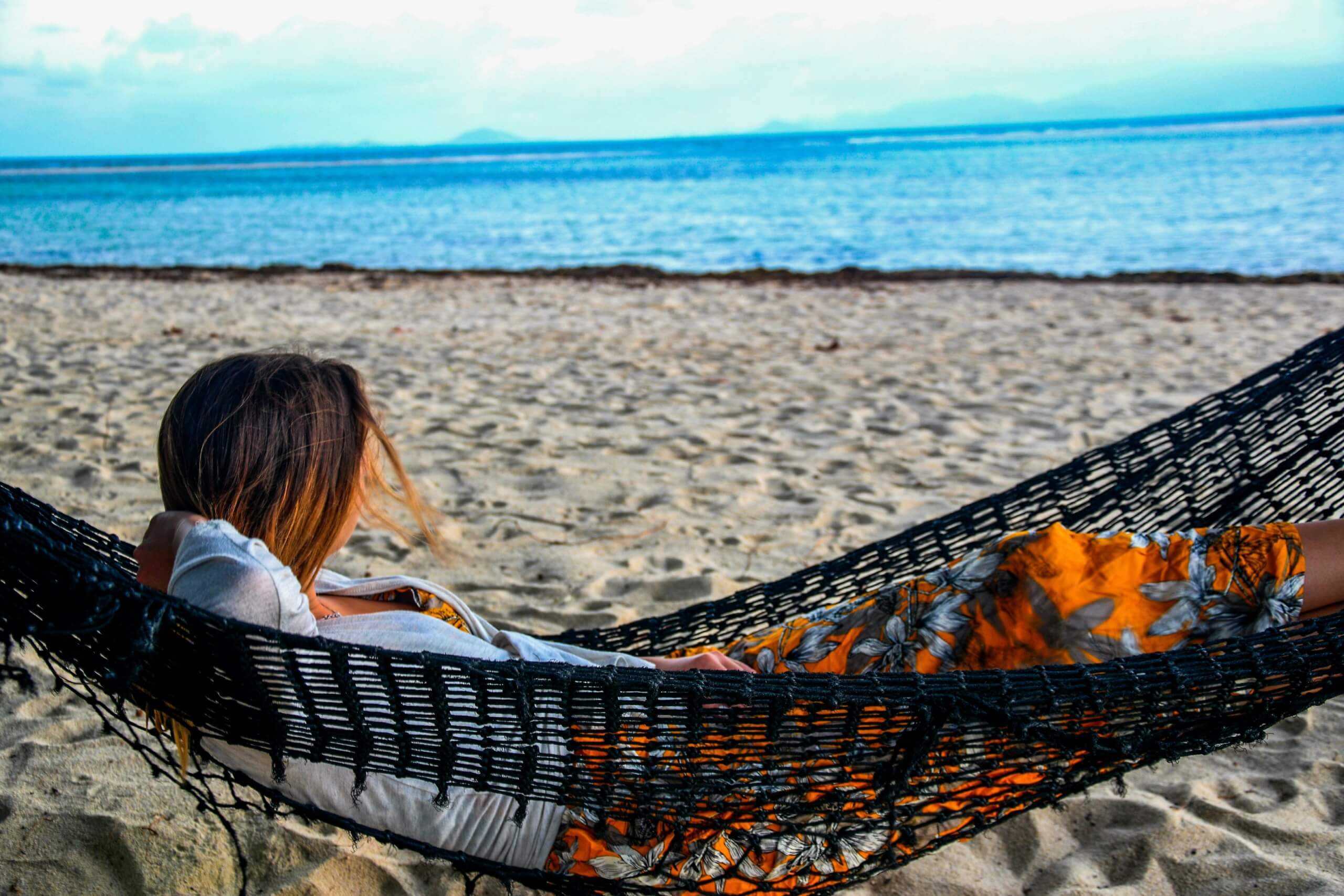 vacation burnout - lady at beach on hammock