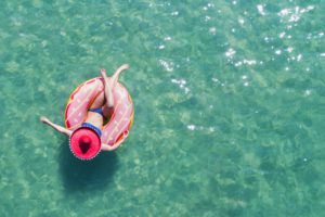 last minute vacation deals woman in pool