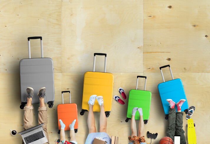 Family is going on a trip, five colored suitcases with clothes and accessories for vacation national plan a cruise month