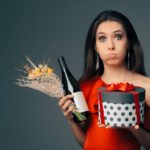 Girl with Gift Box, Wine Bottle and Flower Bouquet Ready for Party hostess gifts