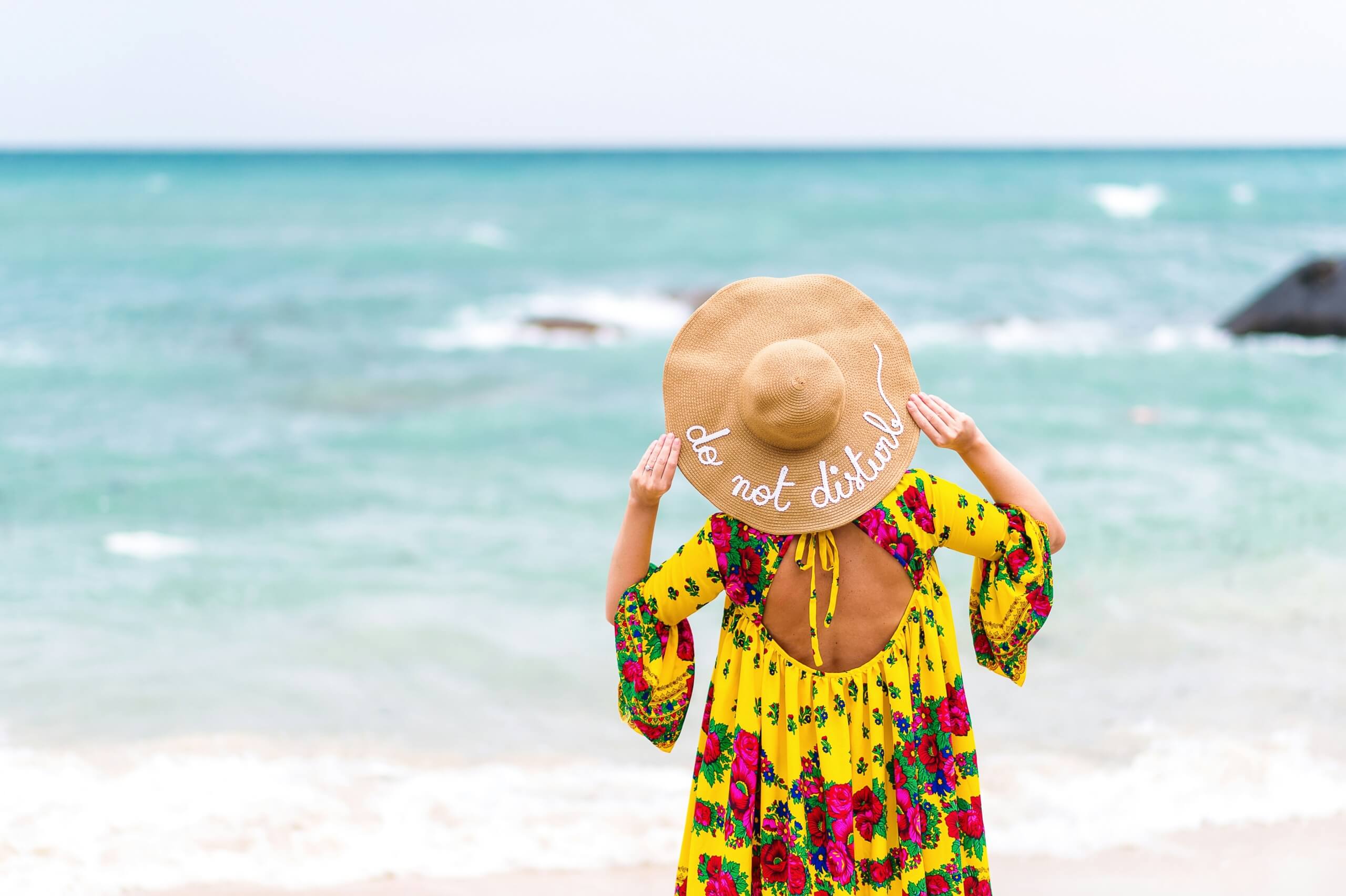 woman standing on the beach - fall beach trips