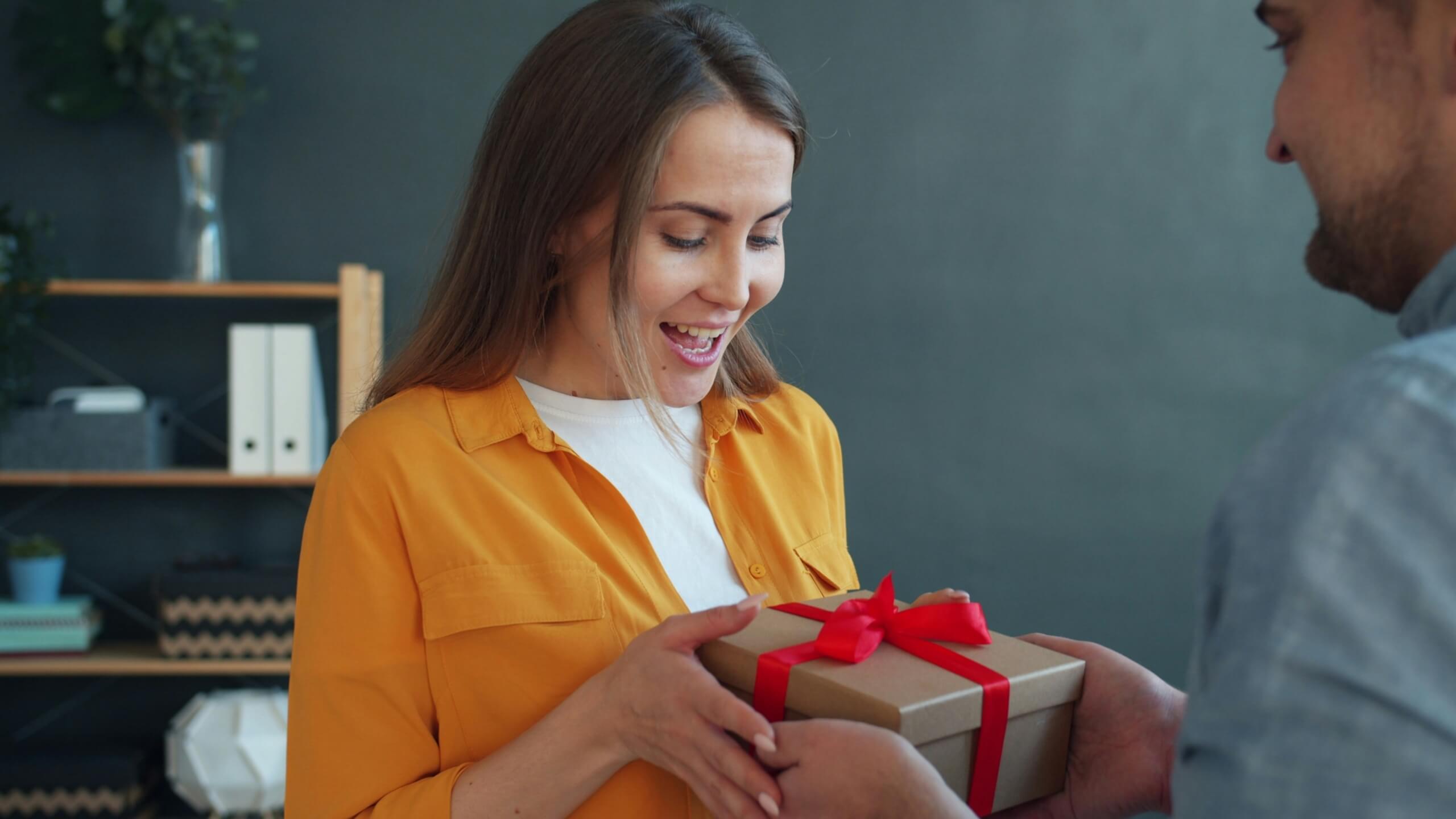 woman receiving a gift Early Jewelry Gift Guide Early Jewelry Gift Guide