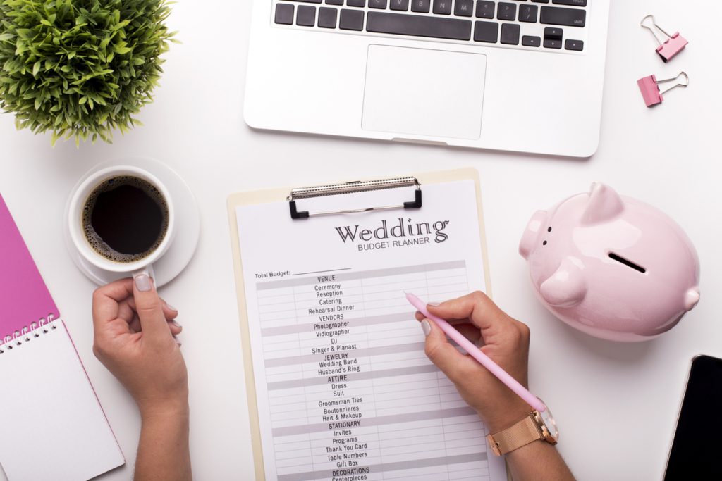 wedding budget Collecting money concept. Woman planning budget before wedding writing ideas on paper stress wedding planning