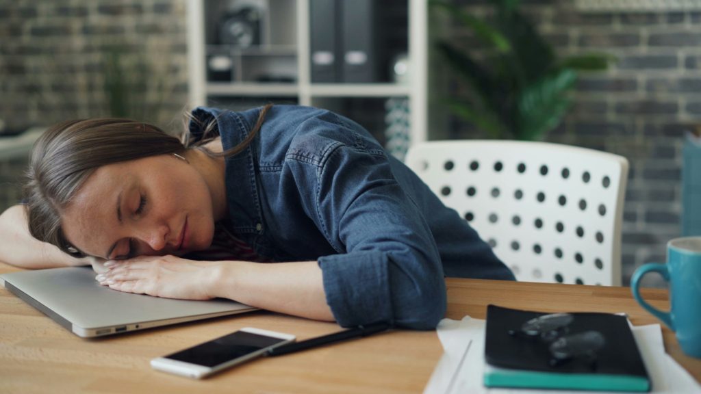 woman falling asleep working on laptop Tips for Sleep Deprived Moms