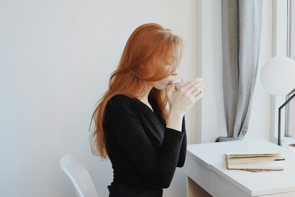 woman sipping hot coffee tea mug cozy drinking