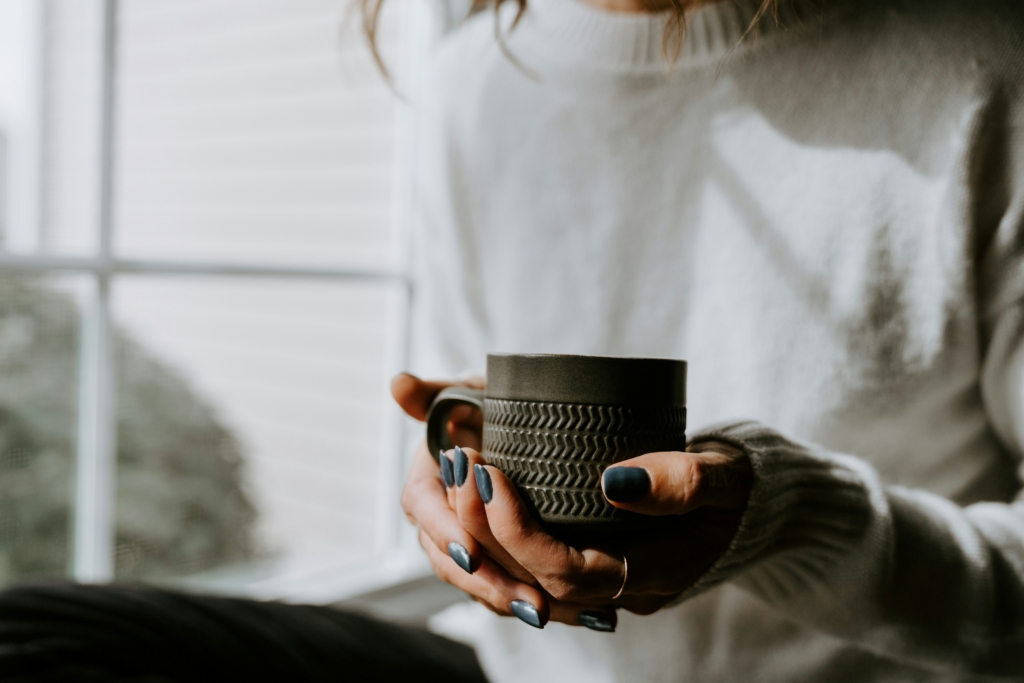 self care sunday ideas woman holding a mug of coffee tea relaxing cozy
